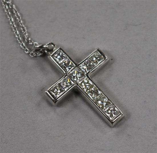 A modern white metal and diamond set cross pendant, on an 18ct white gold chain, pendant 22mm.